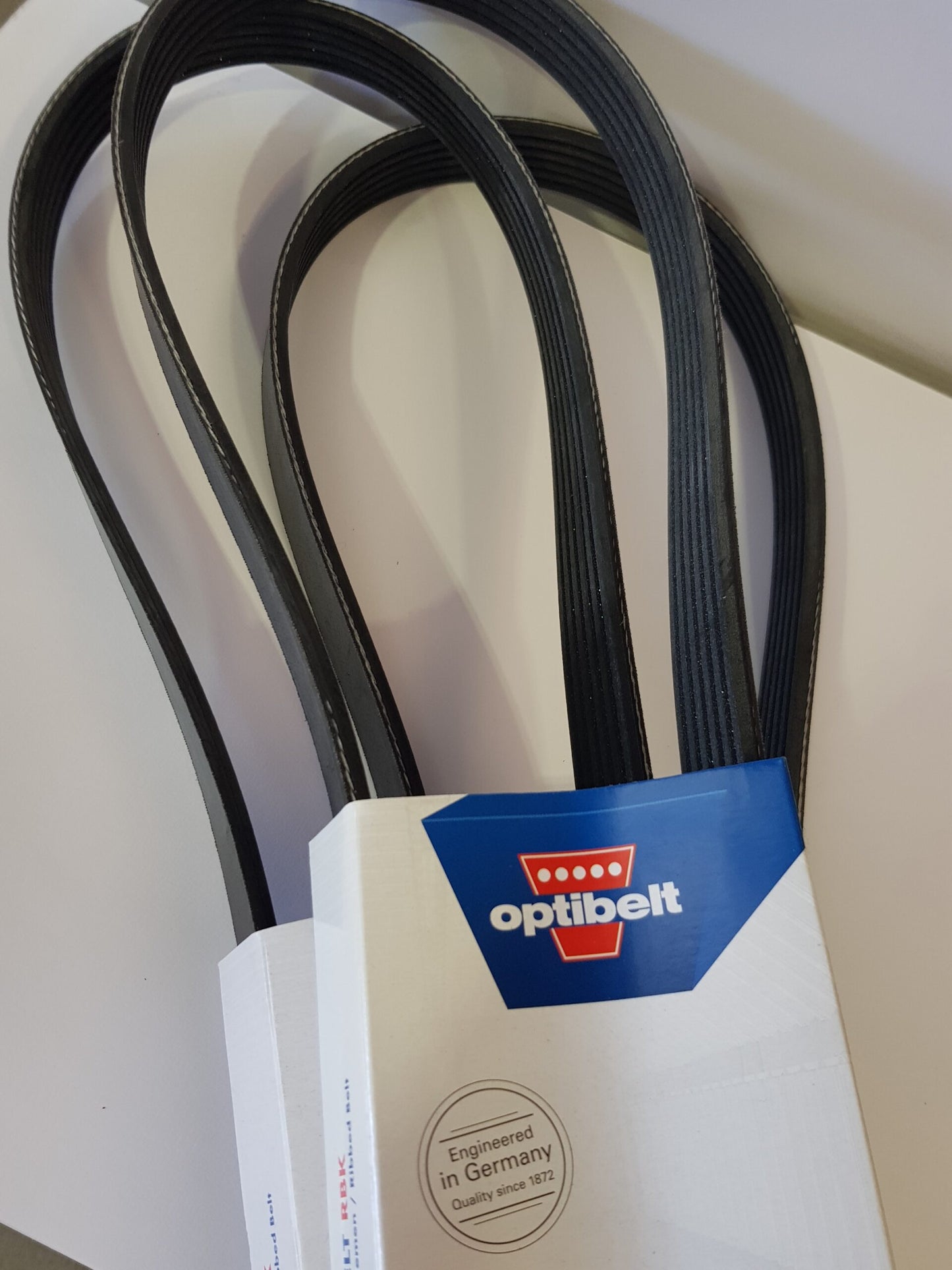 A set of black super charger pulleys for a MINI Cooper S, with the product packaging displaying the brand name 'Optibelt'.
