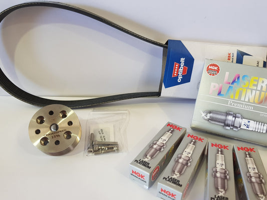 A set of parts for a MINI Cooper S R52/R53 supercharger pulley kit, including a pulley, a drive belt, and a set of NGK Platinum spark plugs.