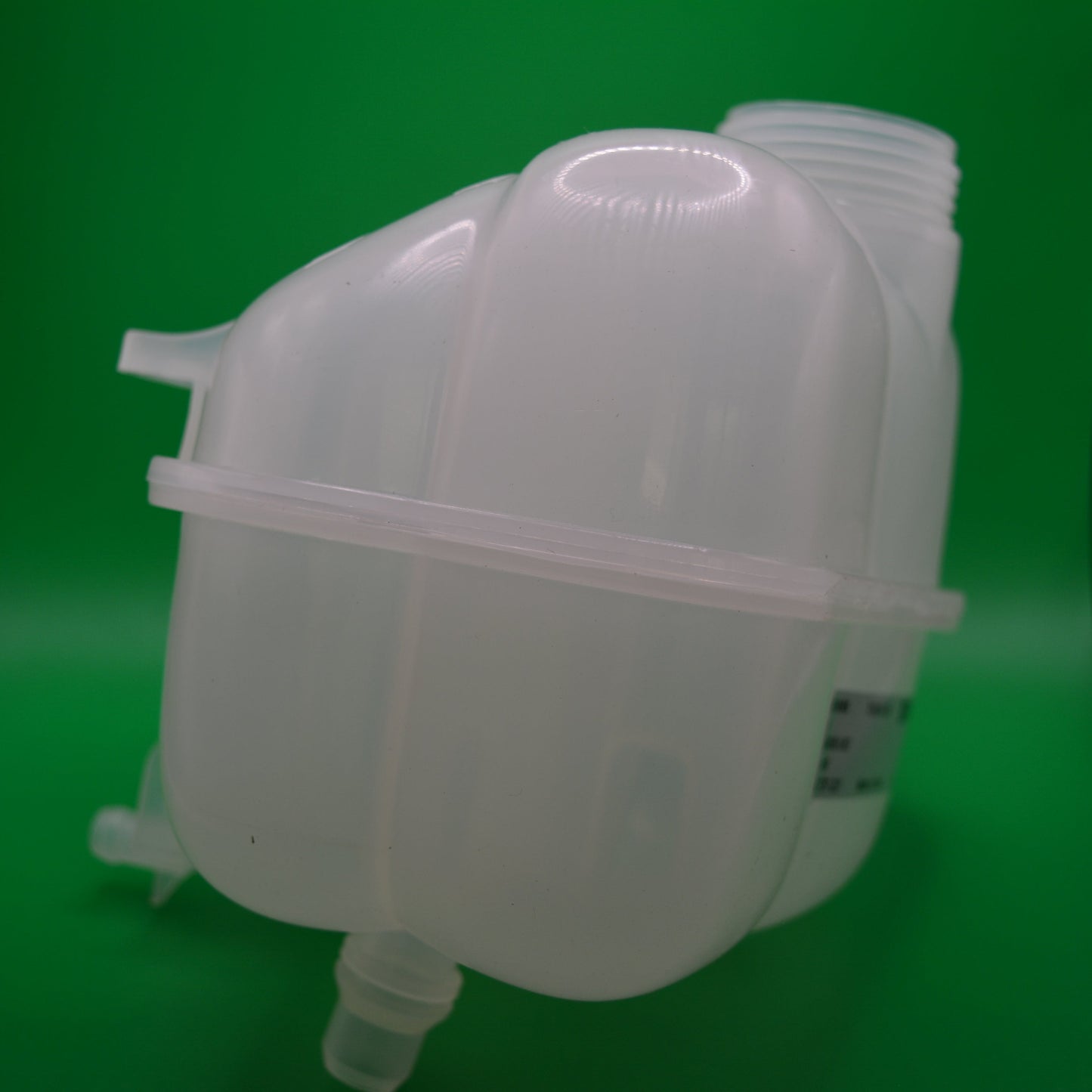A white coolant reservoir bottle designed for R55 and R56 mini cooper vehicles, placed against a green background.