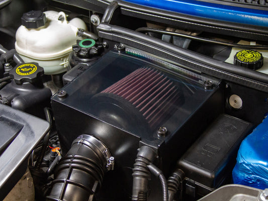 Mini cooper Cold air intake box installed in the engine compartment of a Mini Cooper, featuring a red K&N filter.