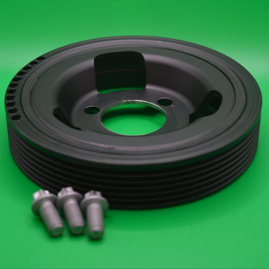 Harmonic balancer/crank shaft pulley for Mini Cooper models, displayed on a green background accompanied by installation bolts.