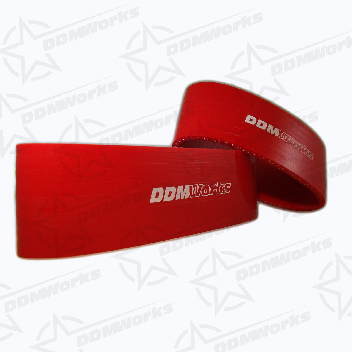 Red silicone intercooler couplers with DDMworks branding on them.