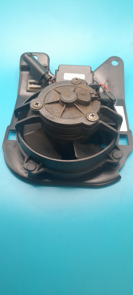Mechanical mini cooper fan component on a blue background