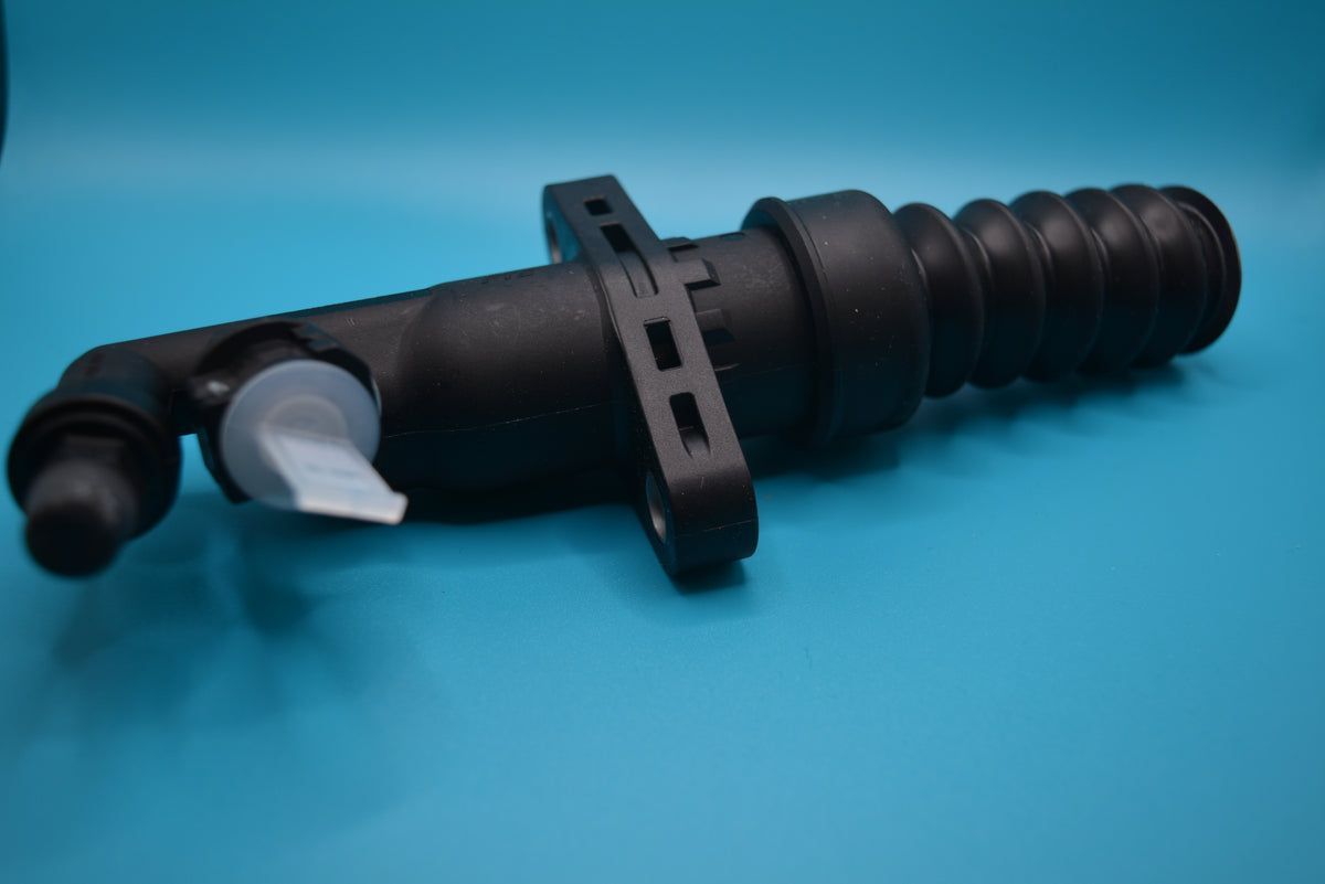 A black Mini Cooper S clutch slave cylinder against a blue background.