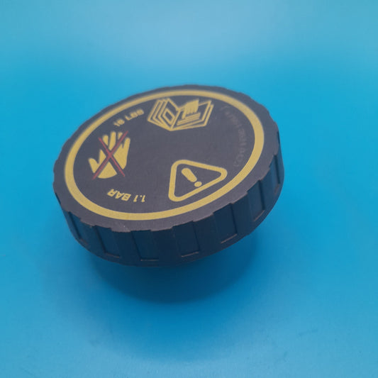 A black and gold R50 Mini Cooper thermostat housing cap 2001-2006