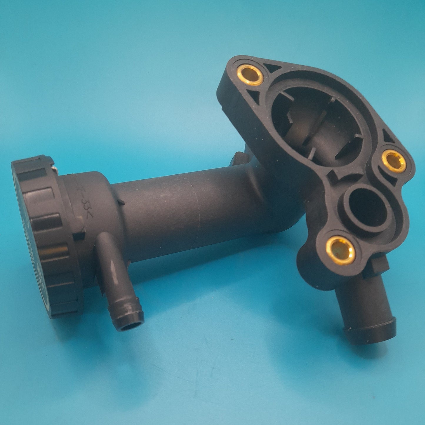 A black R50 Mini Cooper thermostat housing with a cap.