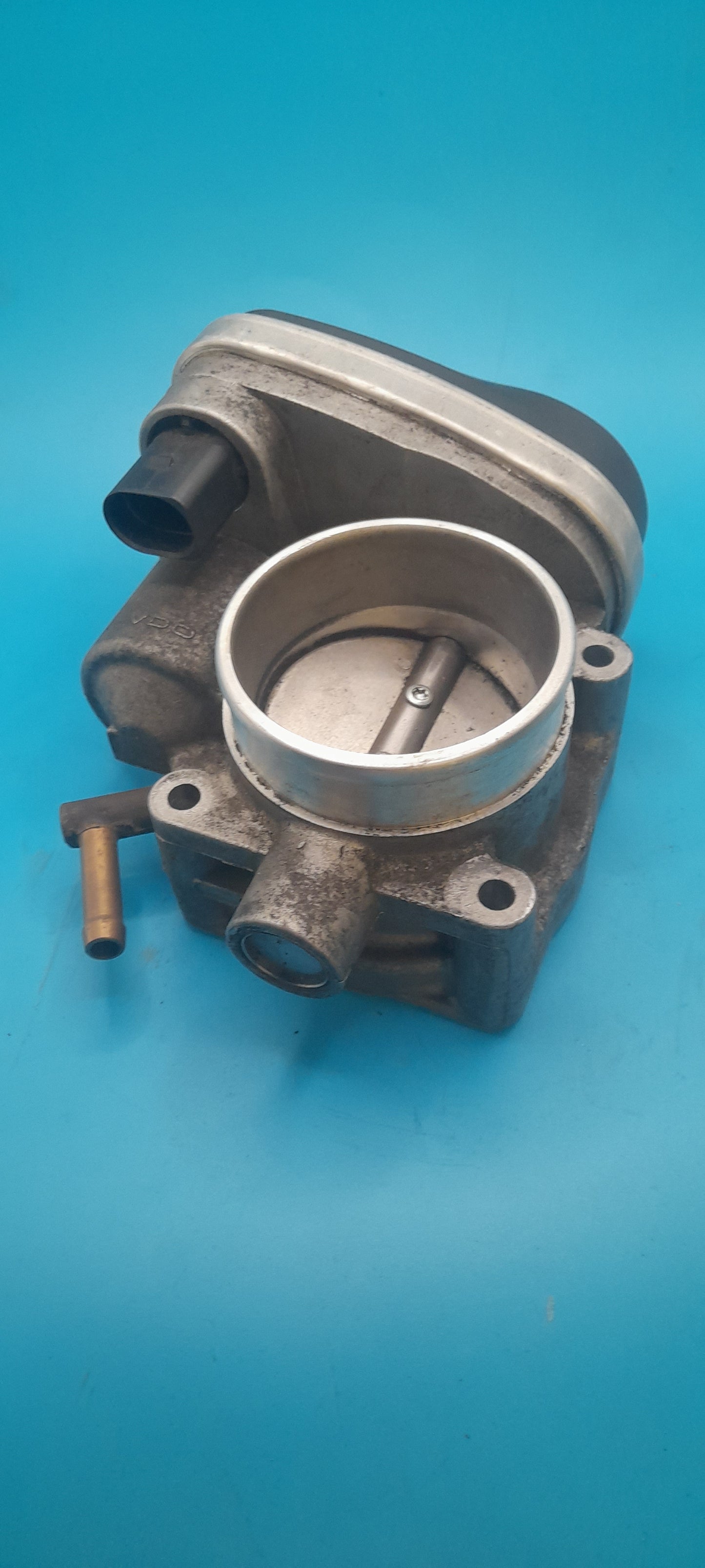 Mechanical throttle body on a blue background