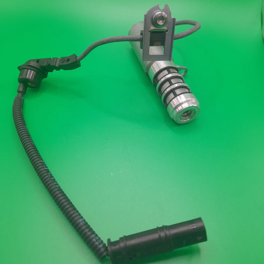 R56 Mini cooper oil control solenoid on a green background