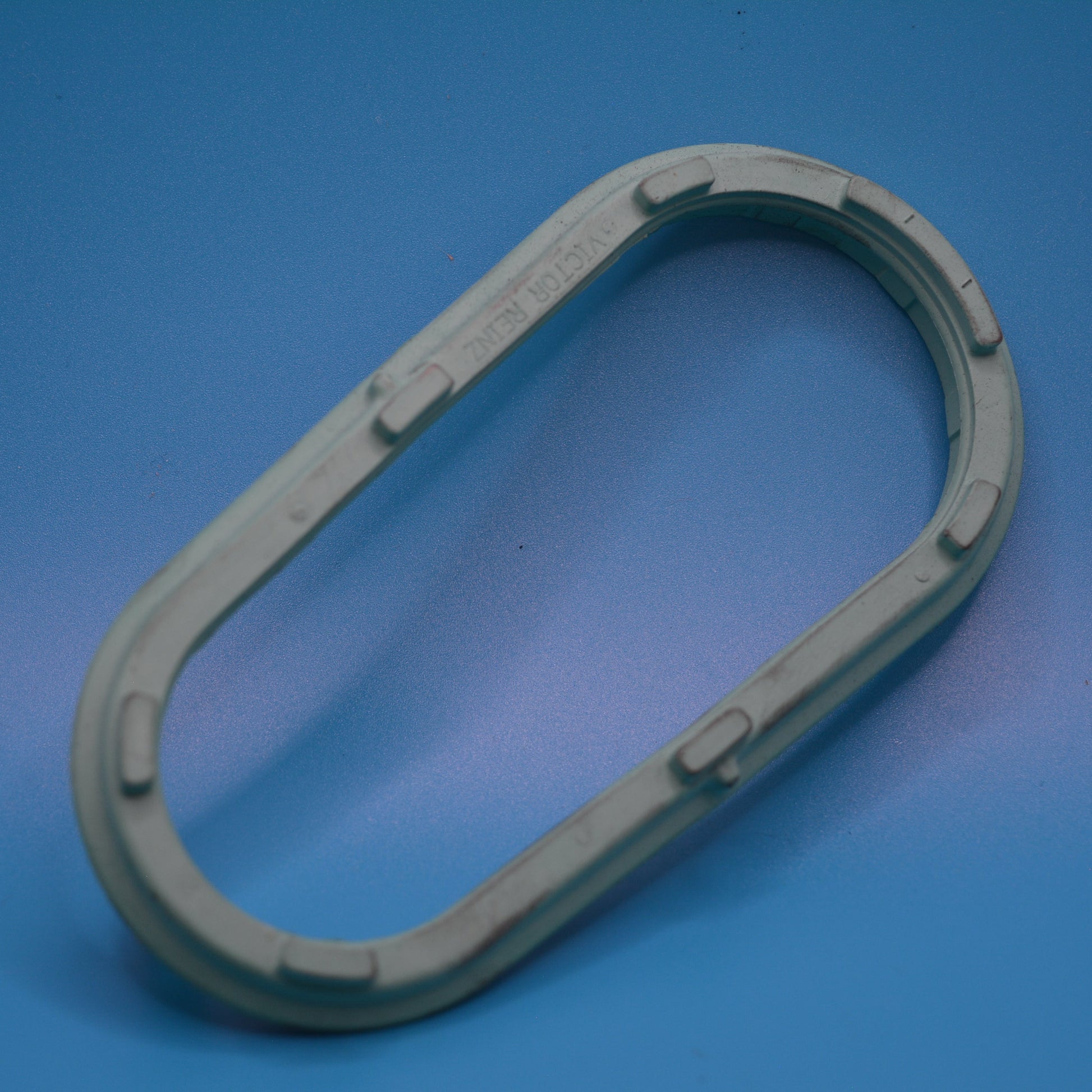 A green Super-Charger Inlet Gasket against Mini cooper s models R52,R53