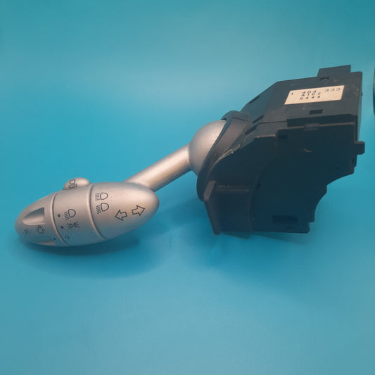 A Mini Cooper combination switch, featuring a stalk with control buttons for lighting and indicators, against a blue background.